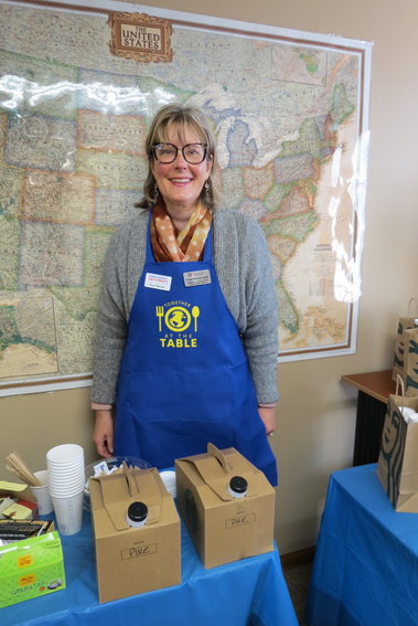 Arapahoe County Commissioner Carrie Warren-Gully, who is a member of the Immigrant Pathways Colorado board, served coffee and donuts at the workshop.